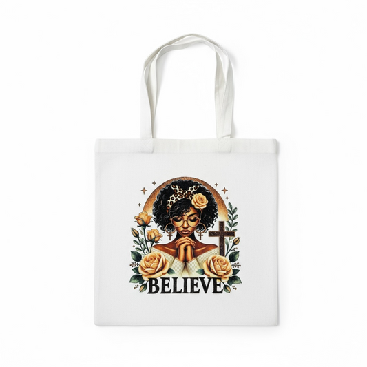White luxury tote bag featuring a beautiful Black woman with the word Believe- Christian inspired tote